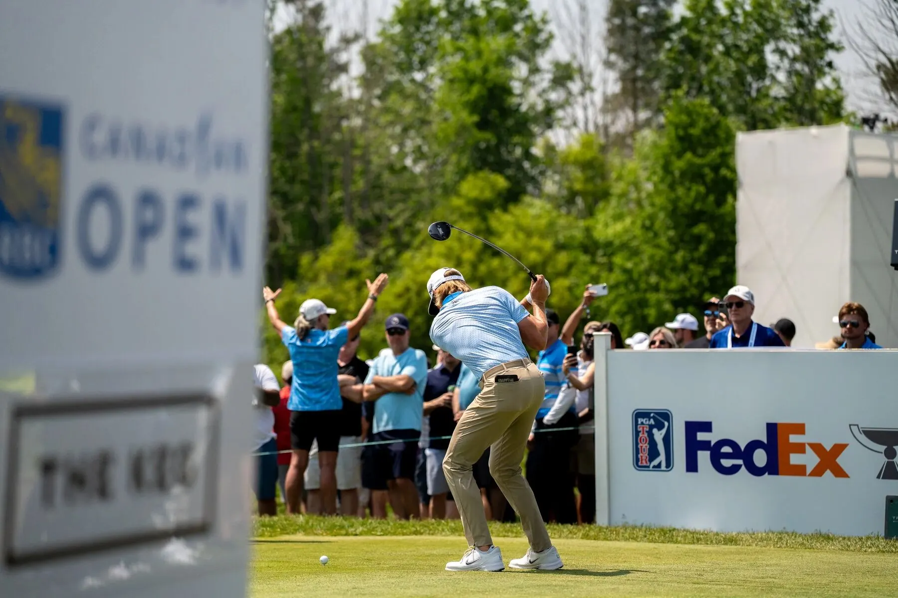 Golfer teeing off at the RBC Canadian Open with FedEx and PGA Tour signage