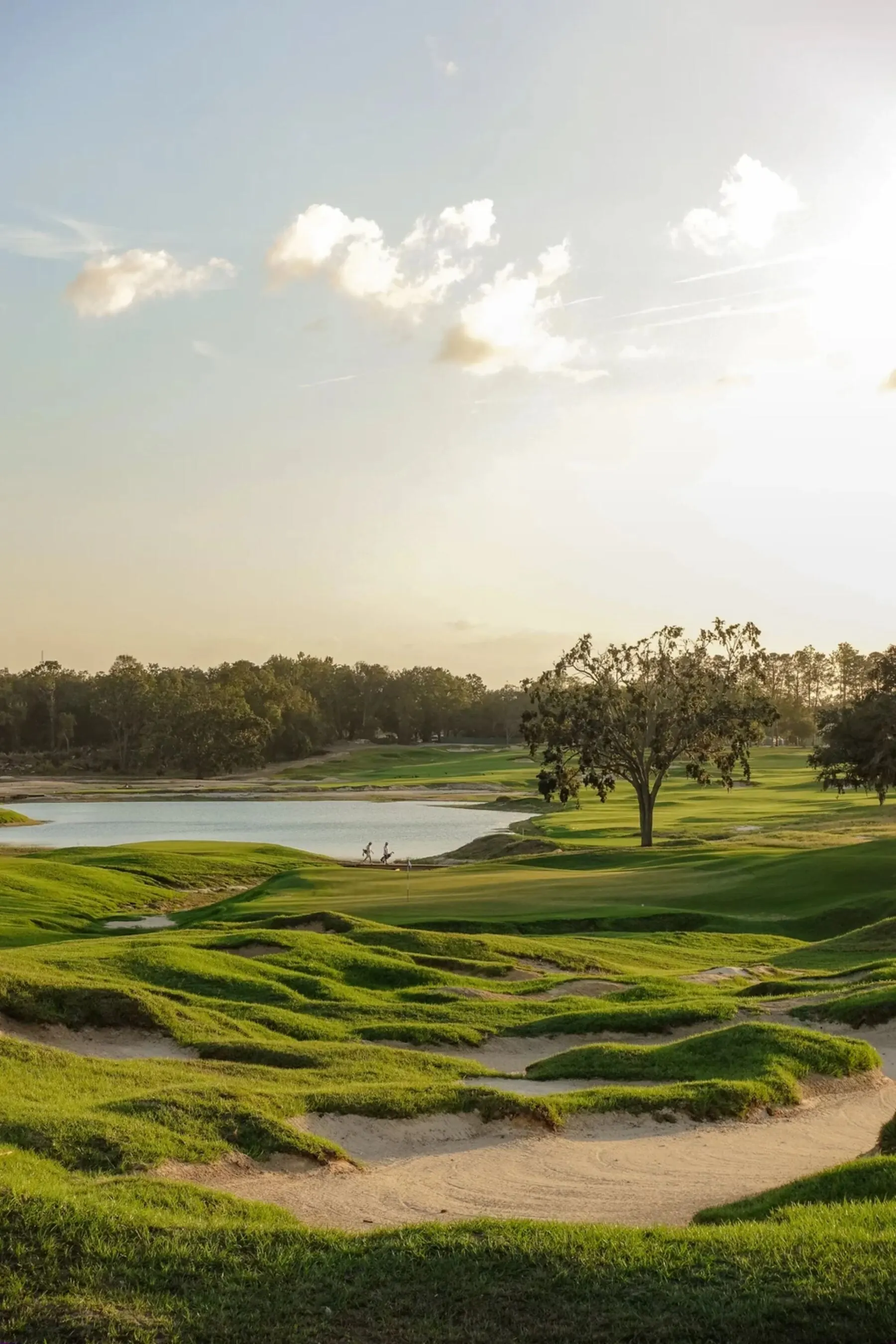 Green with water hazard and bunkers at golden hour