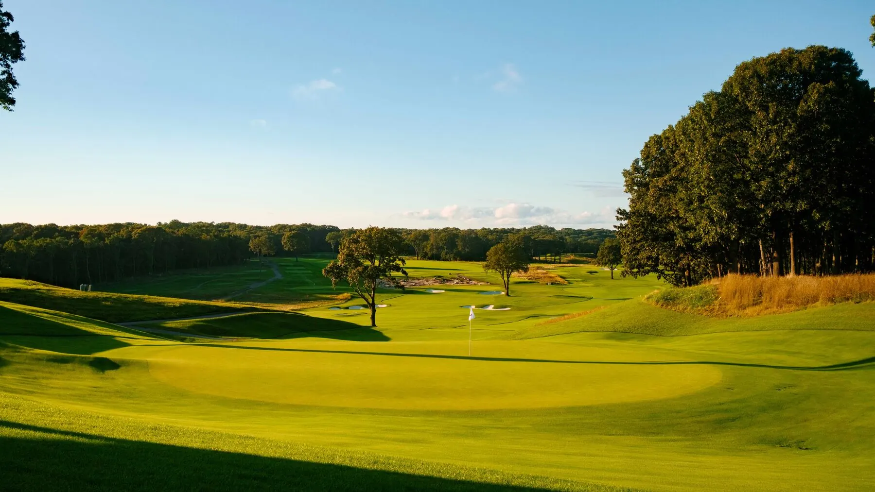 Green and flag at golden hour at Huntington Crescent Club