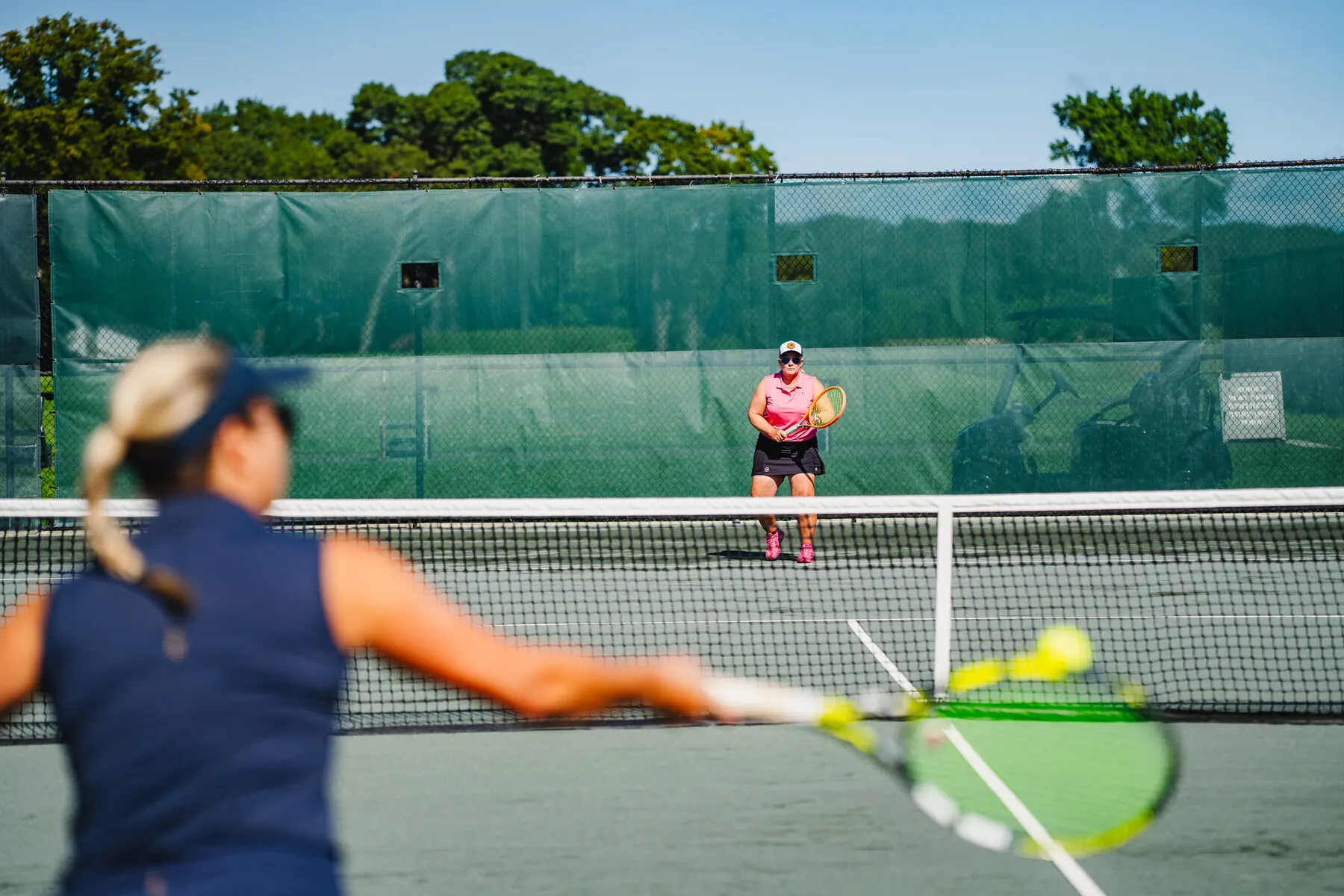 Tennis player on the grass court at Huntington Crescent Club