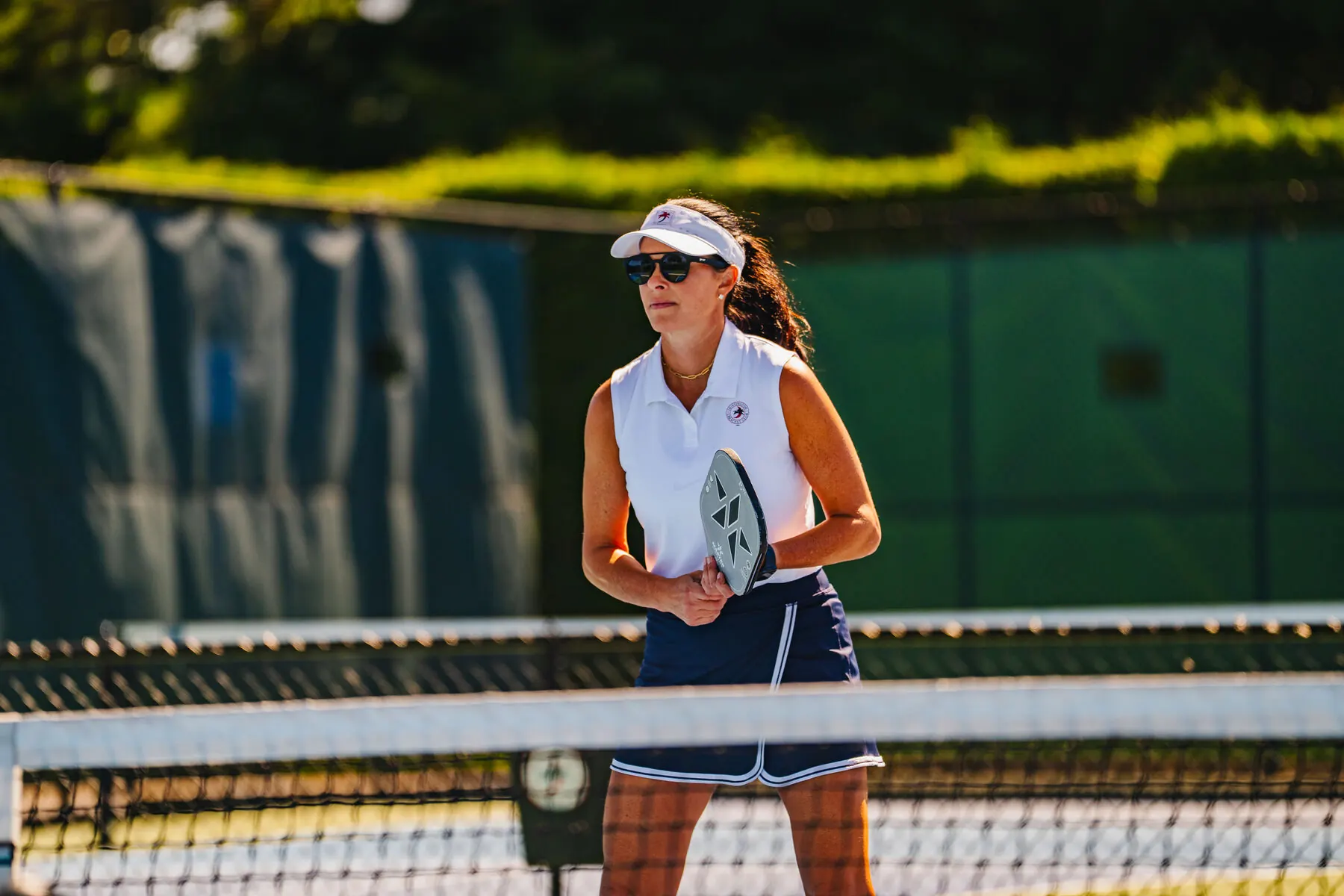 Tennis player on the grass court at Huntington Crescent Club