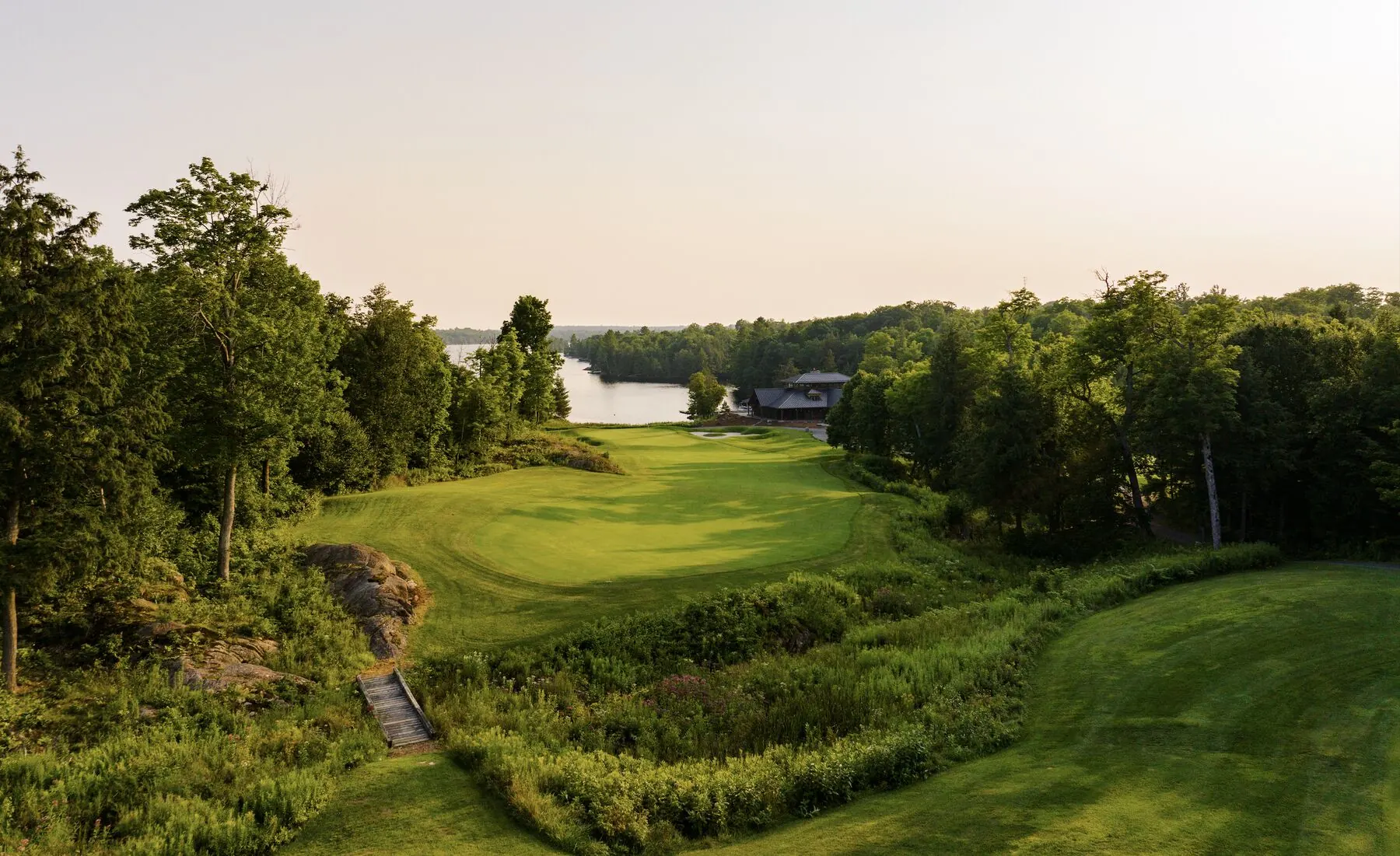 Green with lake and clubhouse beyond at Manitou Ridge