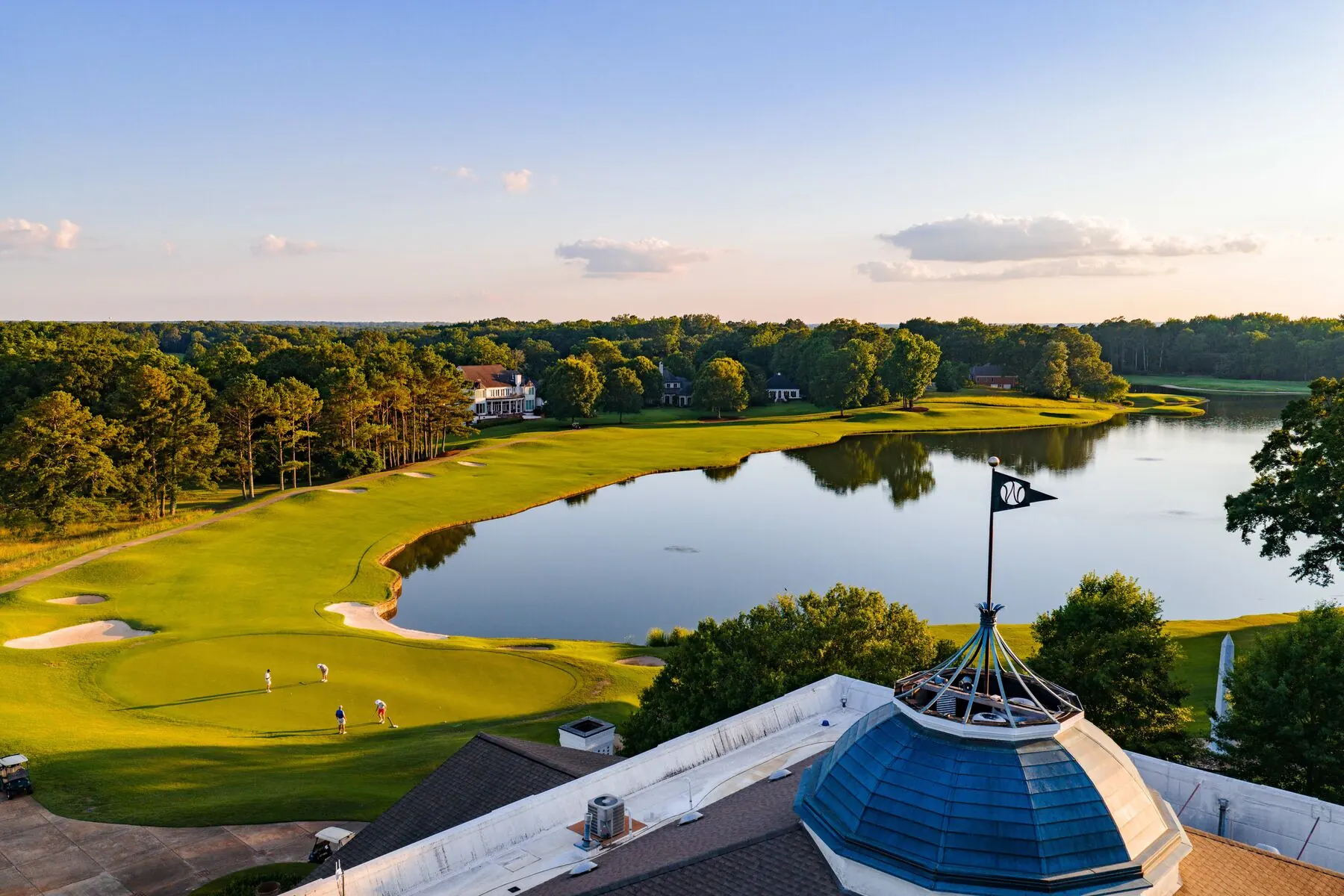 Old Waverly cupola flag with the lake and golfers below