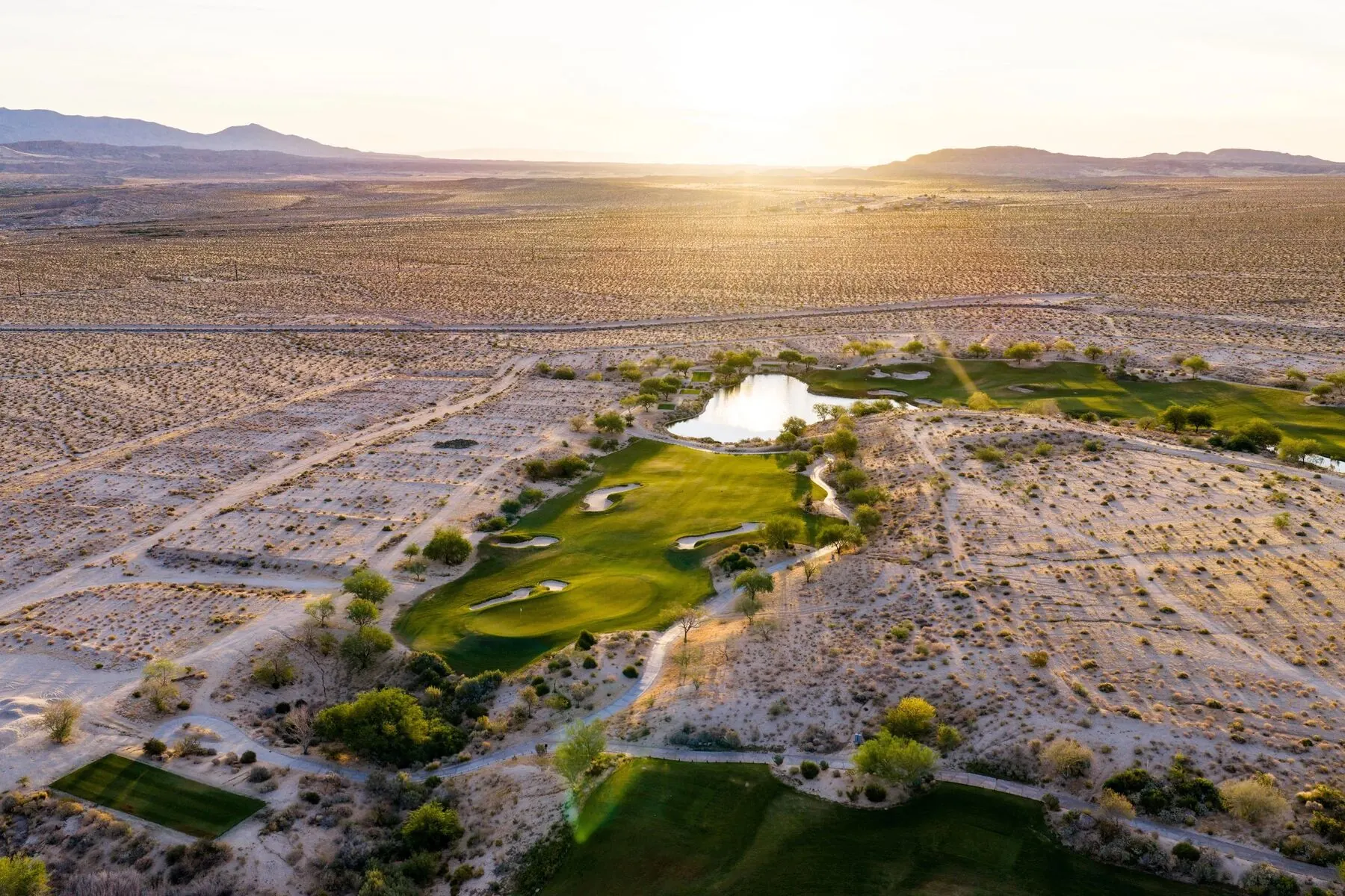 Rams Hill clubhouse and lake at golden hour