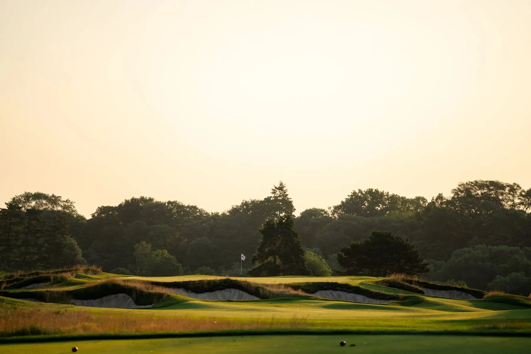 Green and flag at sunset at Toronto Golf Club